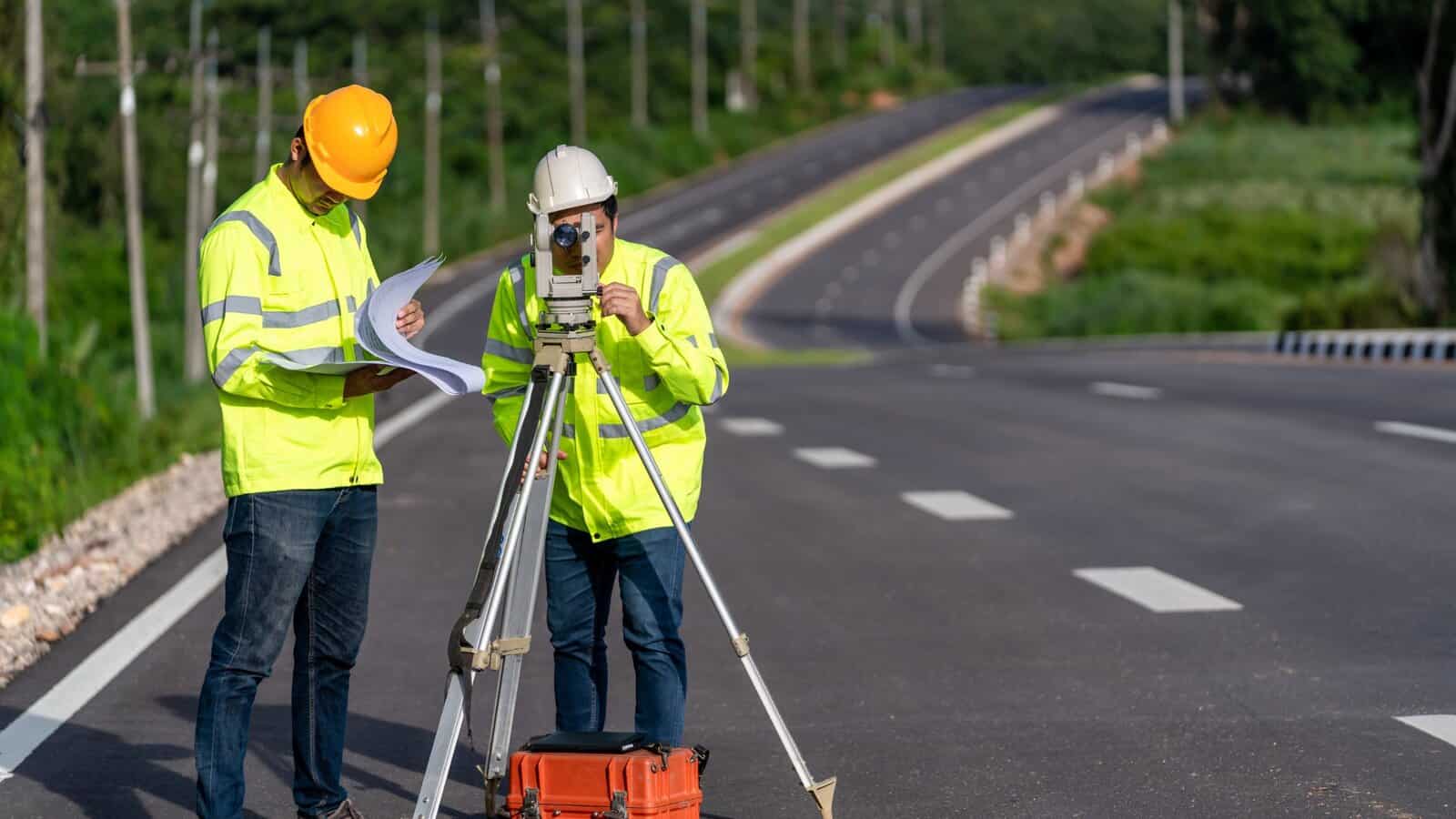 Surveyor measuring a road construction site